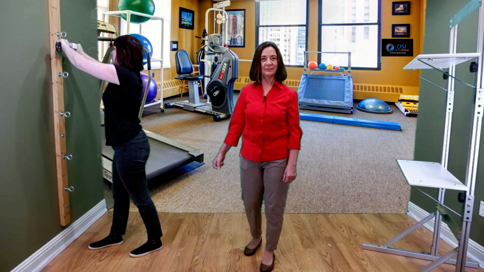 A woman is doing a pull test during a Job Function Based test above her shoulder level.