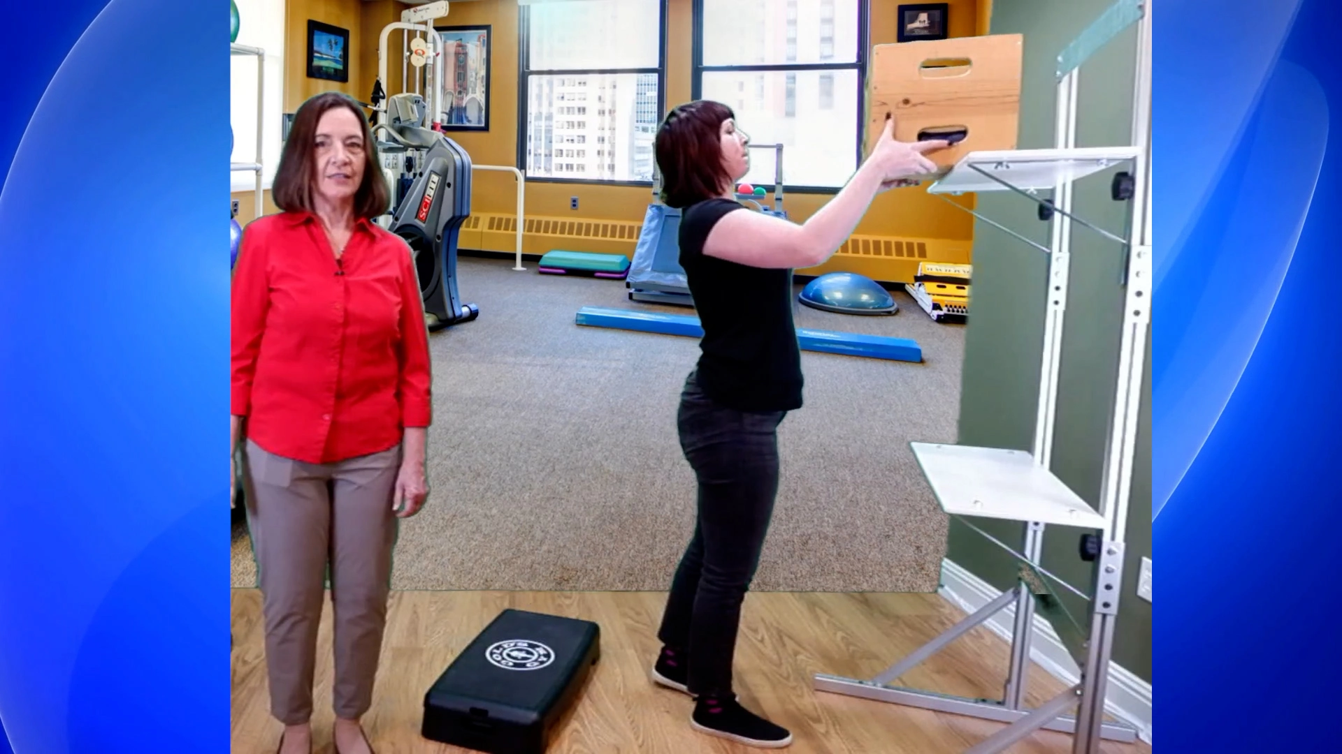 A woman is lifting a box during a Job Function Test to a height above her shoulder level.