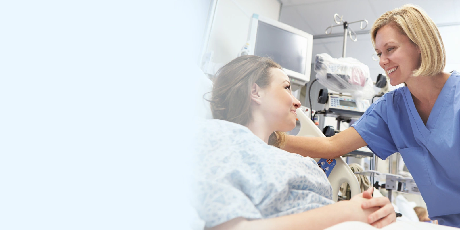 A nurse from a healthcare group is assisting a patient by the bedside.